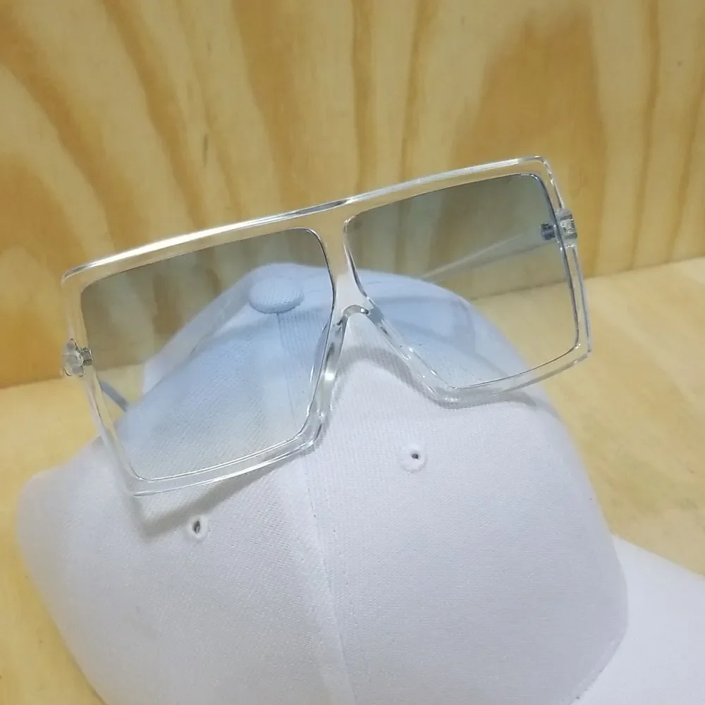 High Fashion Women's Sunglasses with clear frames/ blue tented lenses.
